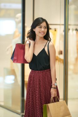 Lovely attractive young woman walking with shopping bags